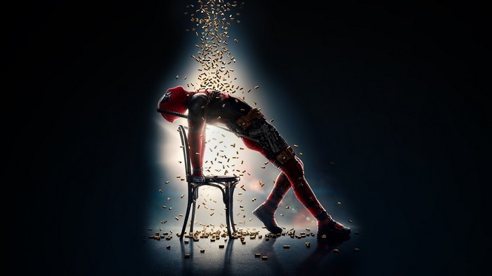 Deadpool leaning on a chair with bullets falling