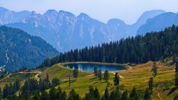 Mountain lake surrounded by pine trees and rocky peaks