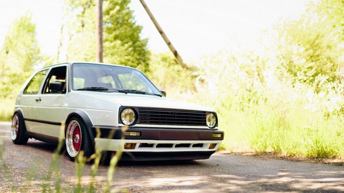 White Volkswagen Golf GTI on a road