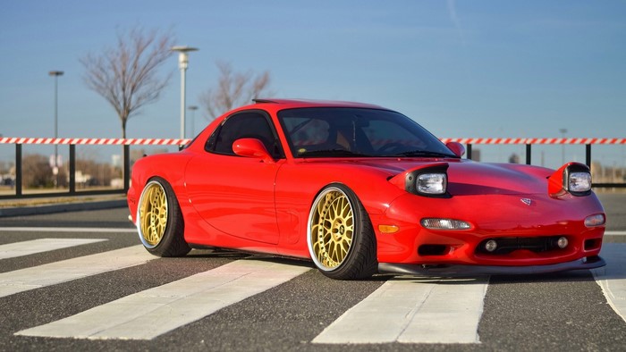 Red Mazda RX-7 on a crosswalk