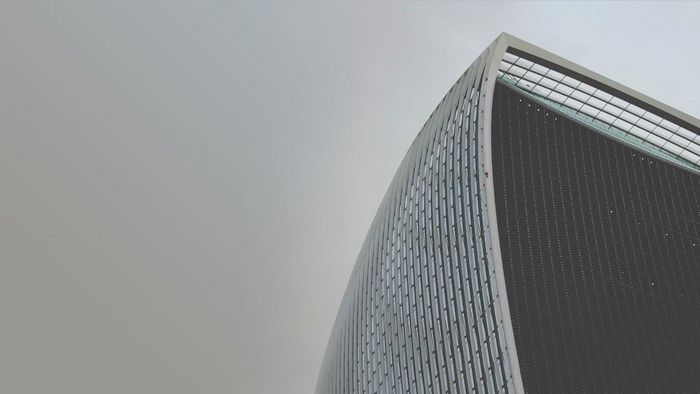 Modern skyscraper against a cloudy sky