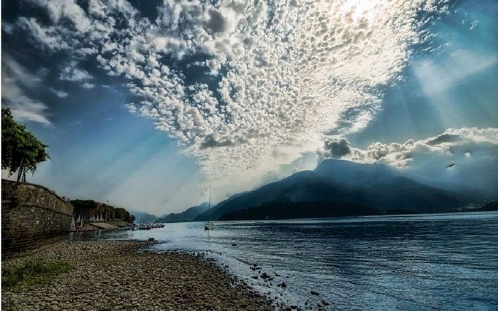 Lake with mountains and dramatic clouds
