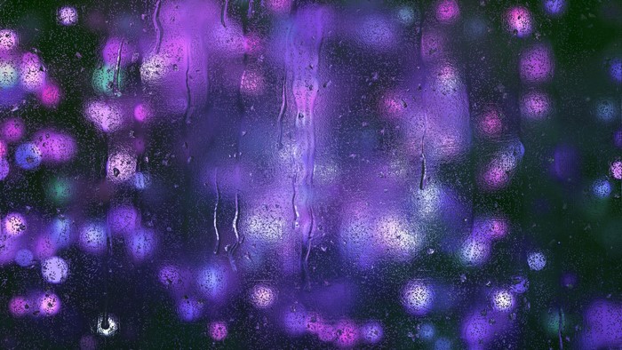 Purple Bokeh Lights Through Water Droplets on Glass