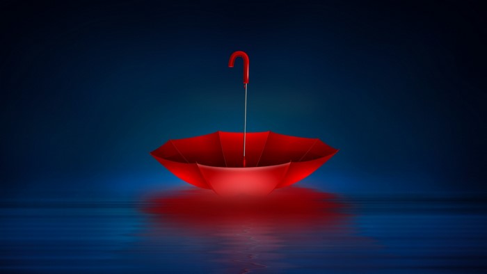Red umbrella on dark blue background