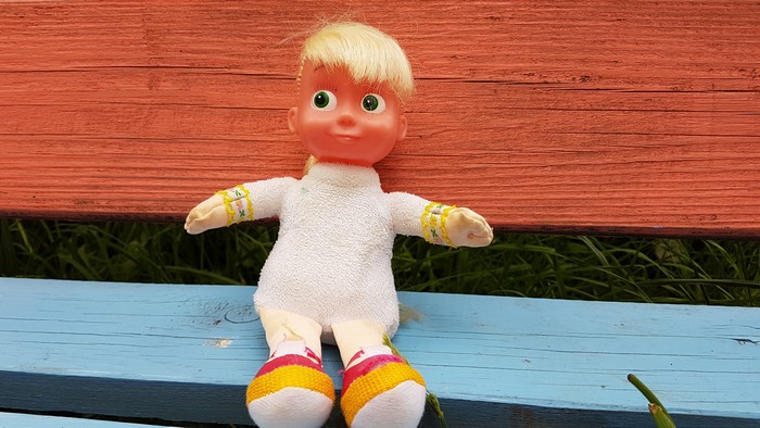 4K Masha doll sitting on a bench