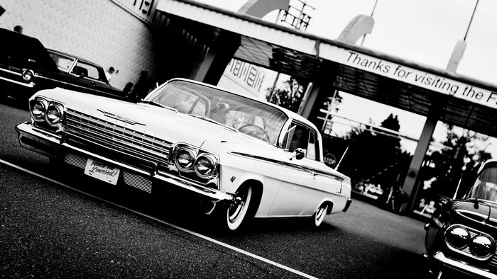 White Chevrolet Impala parked near a building