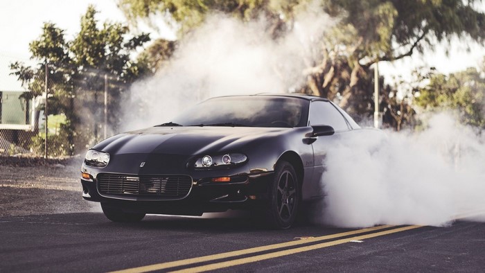 Black Chevrolet Camaro Z28 doing a burnout