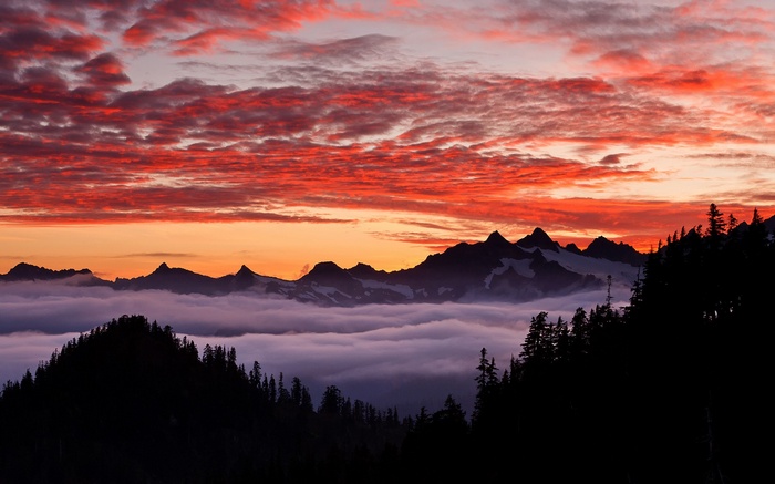 Mountain range at sunset with clouds and trees