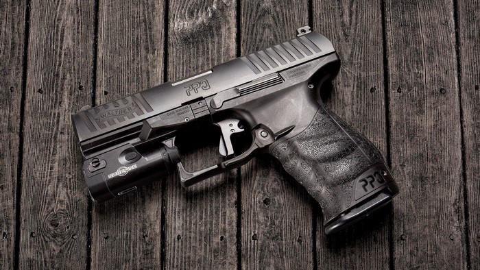 Walther PPQ pistol with SureFire light
