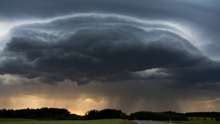 Dark storm clouds over a rural landscape