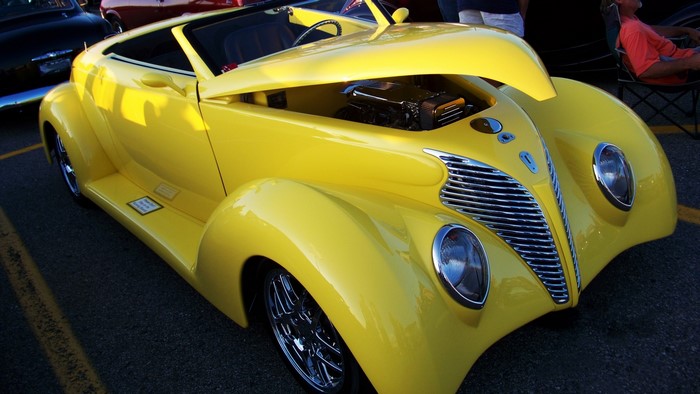 Yellow 1939 Ford Roadster with open hood