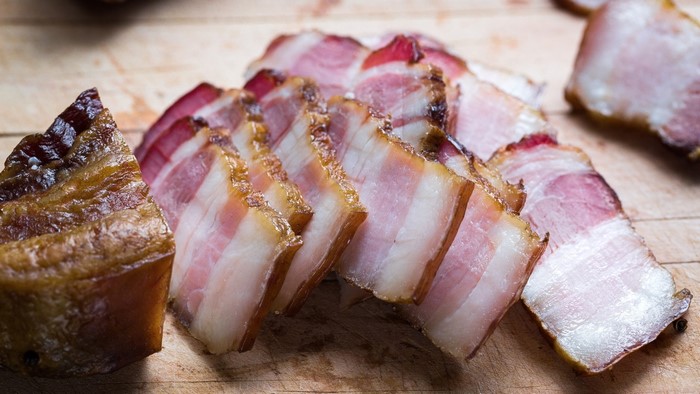 Slices of smoked bacon on a wooden board