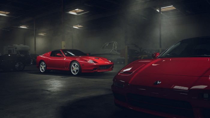 Red Ferraris and Honda NSX in a Garage