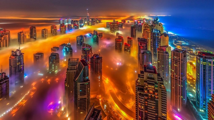 Dubai skyscrapers shrouded in fog at night
