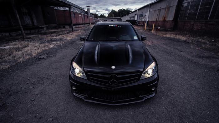 Black Mercedes-Benz C63 AMG parked on gravel road
