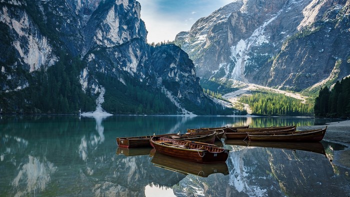 Wooden boats on a lake in the Dolomites, Italy
