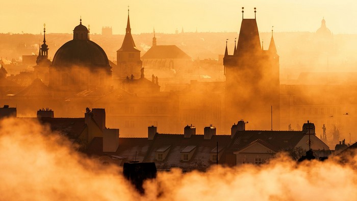 Prague cityscape at sunrise with fog