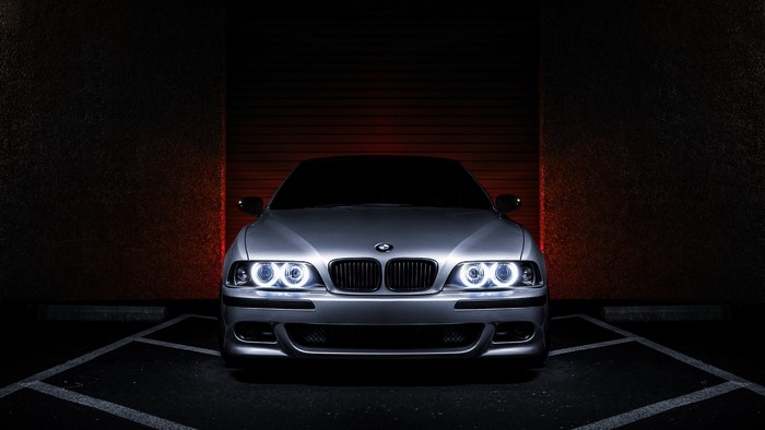 Silver BMW parked in a dark garage