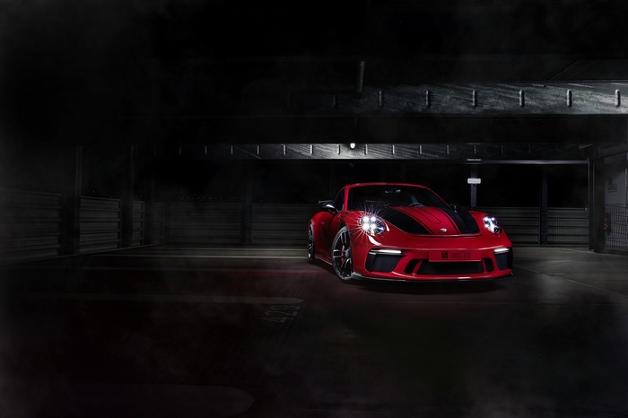 Red TechArt Porsche 911 GT3 in a dark garage