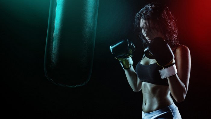 Woman boxing with a punching bag