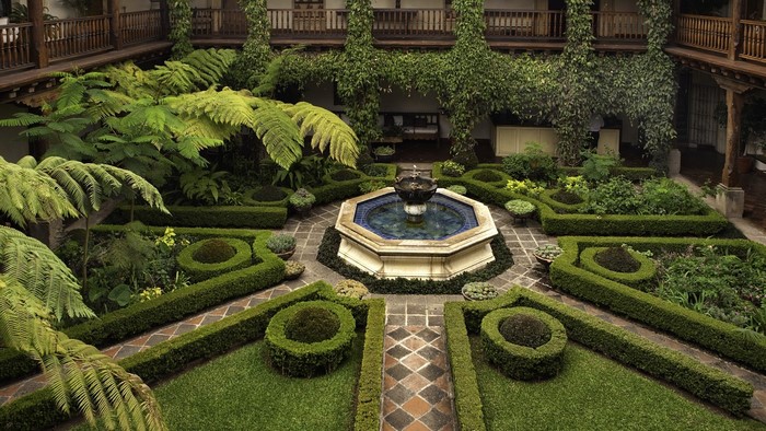 Courtyard garden with octagonal fountain and manicured hedges