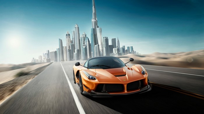 Orange Ferrari LaFerrari driving on a road with Dubai skyline