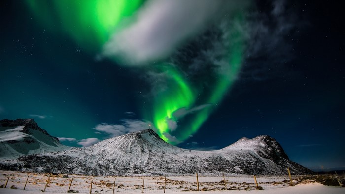 Northern Lights over Snowy Mountains