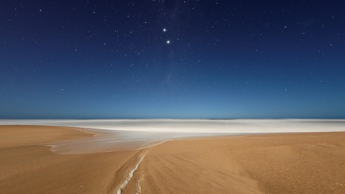 Starry night sky over a beach