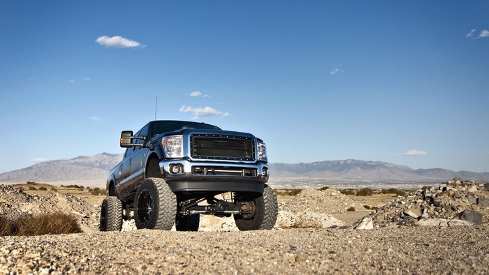 Lifted Ford F250 truck in desert landscape