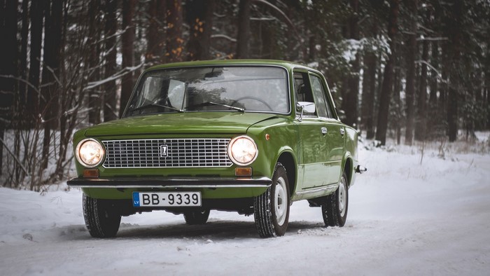 Green Vaz 2101 car in a snowy forest