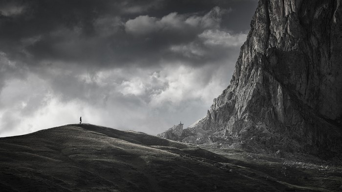 Person on a mountain ridge in the Dolomites, Italy