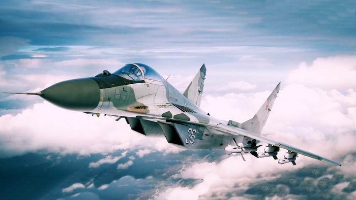 Russian MiG-29 fighter jet flying through clouds