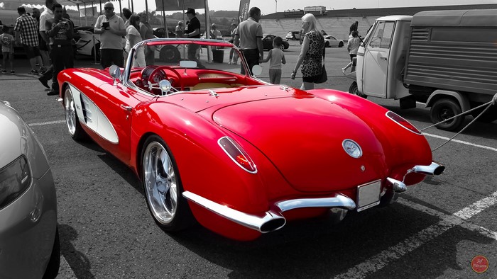 Red classic convertible car at an outdoor event