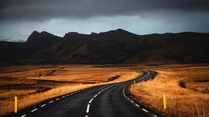 Road through Iceland landscape with mountains