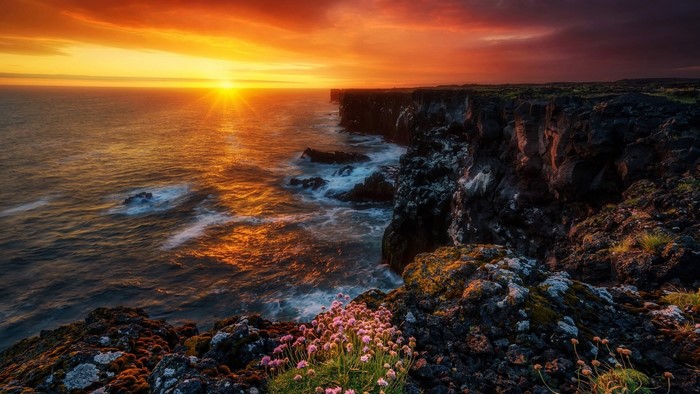 Sunset over the ocean cliffs in Iceland