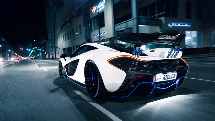 White McLaren P1 driving at night