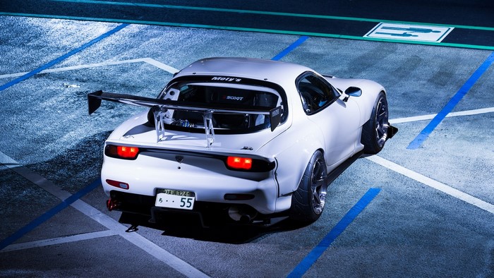 White Mazda RX-7 with large rear spoiler