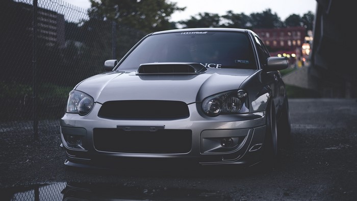 Silver Subaru Impreza parked on wet asphalt