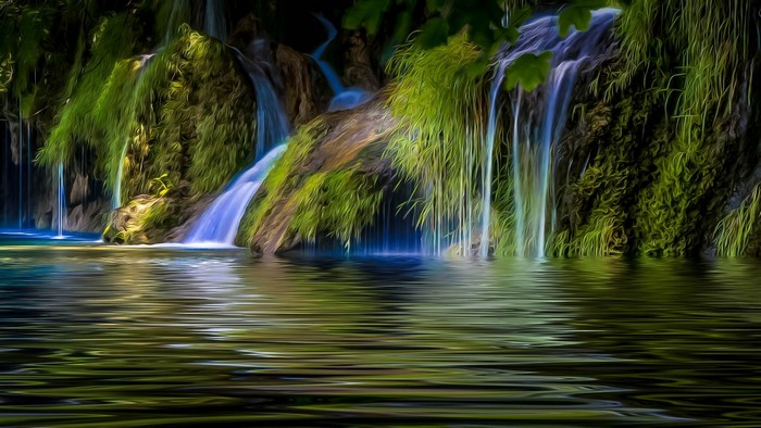 Waterfalls cascading over mossy rocks into a pool