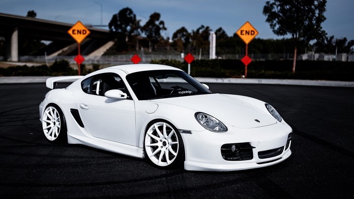 White Porsche Cayman with custom wheels