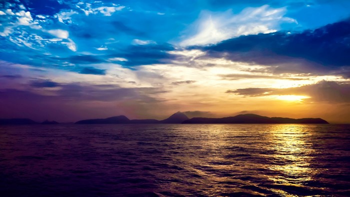 Sunset over the ocean with islands