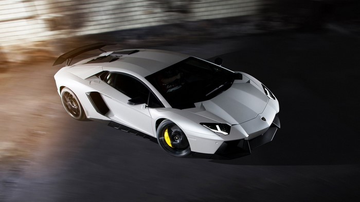 White Lamborghini Aventador driving fast