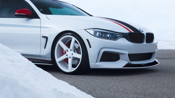 White BMW M4 Coupe with racing stripes