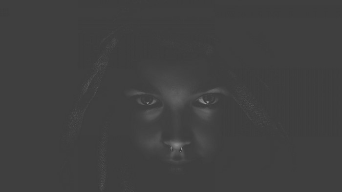 Person with nose ring wearing a hood
