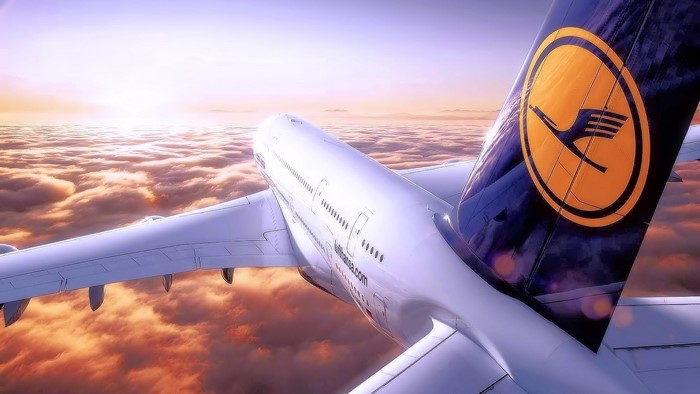 Lufthansa Airplane flying above clouds at sunset