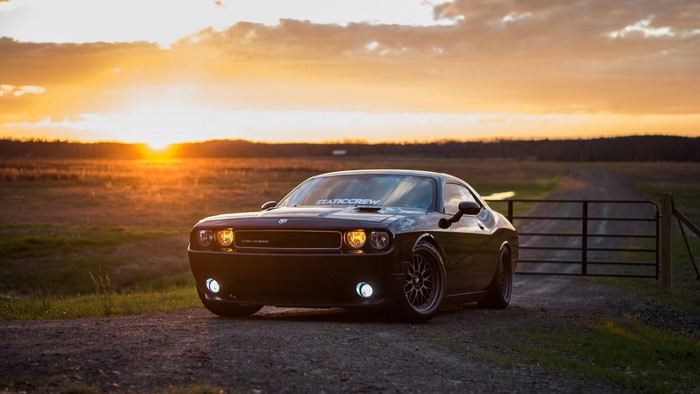Dodge Challenger parked at sunset