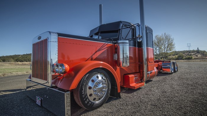 Peterbilt 379 semi-truck with orange and black cab