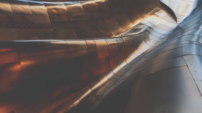 Curving metallic facade with rivets