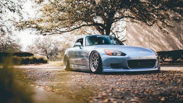 Blue Honda S2000 parked under a tree