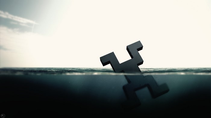Black puzzle piece drowning in the ocean